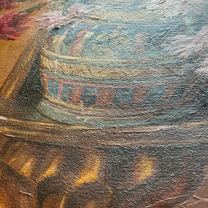 May include: Close-up of a vintage oil painting featuring a detailed depiction of a stack of colorful, striped fabric. The fabric is arranged in a circular pattern and appears to be resting on a wooden surface.