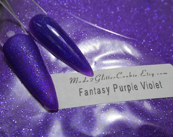 May include: Purple glitter with a holographic finish. The glitter is shown on a white background with a label that reads "Made2GlitterCookie.Etsy.com Fantasy Purple Violet".