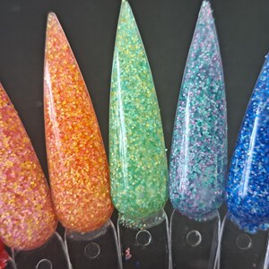 Può includere: Un set di dieci smalti per unghie in un gradiente arcobaleno. I colori sono rosso, arancione, giallo, verde, blu, viola, rosa, bianco, nero e marrone. Ogni colore ha una finitura glitter.