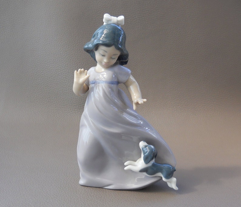1992, by puppy, Daisa year Nao Lladro issue followed by Girl porcelain statuette 1987 called backstamped followed by statuette Lladro 1987 Girl called issue by Daisa porcelain puppy, year Nao backstamped 1992,