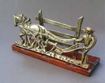 Letter rack showing Ploughman  and horse on wooden plinth