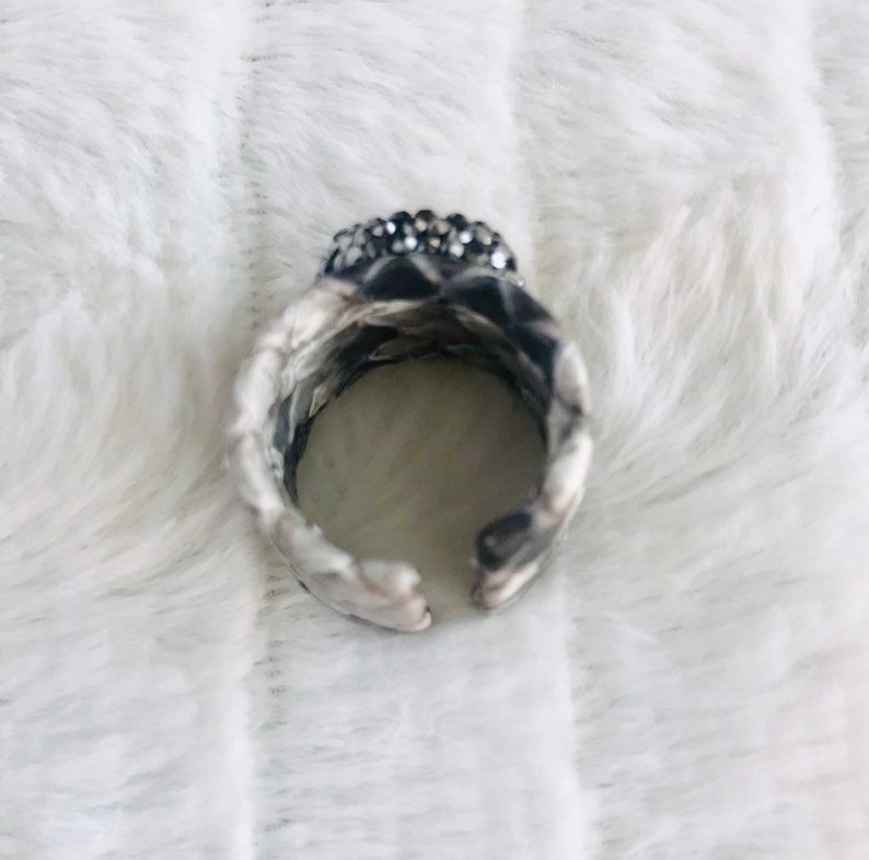 Faceted red garnet ring with druzys set in a grey shaded python adjustable band.