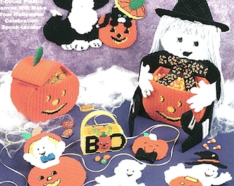 May include: A collection of handmade Halloween decorations, including a black cat, a witch, pumpkins, and ghosts. The decorations are made from yarn and plastic canvas. The text on the image says "Exciting Designer Stitched Using 7-Count Plastic Canvas Will Make Your Halloween Celebration Spook-tacular."