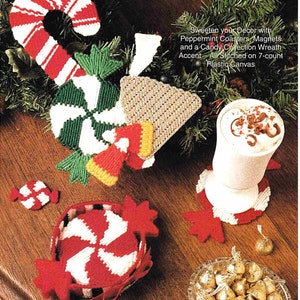 May include: Handmade Christmas decorations featuring peppermint designs, including coasters, magnets, and a candy wreath, stitched on 7-count plastic canvas. The items are in red, white, green, and yellow. The image text reads "Sweeten your Decor with Peppermint Coasters, Magnets and a Candy Collection Wreath Accent - All Stitched on 7-count Plastic Canvas."