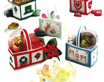 May include: A collection of handmade, plastic canvas baskets in various colors, each with a handle and filled with small gifts. Designs include a shamrock, heart, teddy bear, and the word "MOM". Some baskets have decorative tulle.