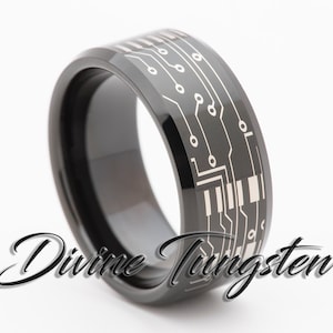 May include: A black tungsten ring with a silver circuit board design. The ring is beveled and has a polished finish.