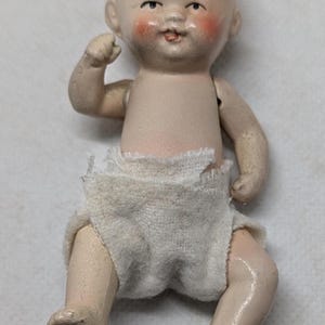 Antique German-made Bisque Baby Doll with Jointed Arms and Legs