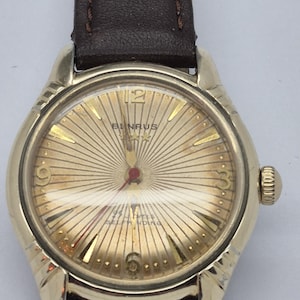 May include: A set of three ceramic mugs with a speckled, matte finish. The mugs are in shades of cream, light gray, and dark gray. Each mug has a simple, minimalist design, perfect for coffee or tea.