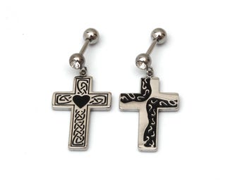 May include: Two silver-toned cross earrings with black Celtic knot designs and a heart in the center. Each earring has a barbell post with a small, clear gem and a round ball. The crosses are hanging from the barbell.