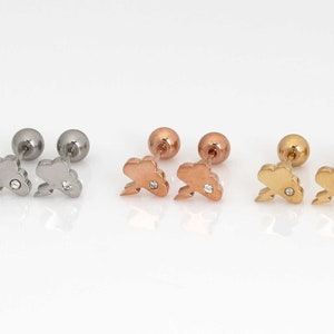 May include: Three pairs of earrings with a cloud and lightning bolt design. The earrings are available in silver, rose gold, and gold.