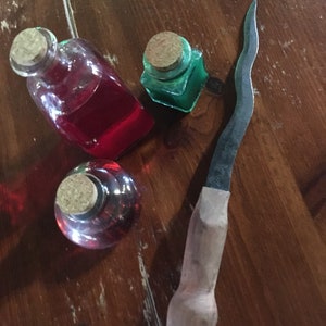 Athame in various materials: hand hardened steel with engraving and handle in wood, wrought iron and corrugated blade. Extremely beautiful objects