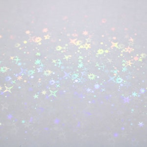 May include: A white background with a gradient of iridescent stars scattered across the surface.