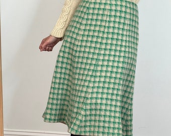 May include: A green and white gingham skirt with a flared silhouette.