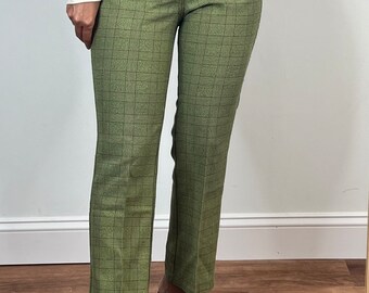 May include: Green plaid pants with a white belt and black heeled sandals.