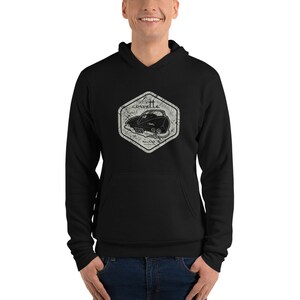 May include: Black hoodie with a distressed white graphic of a vintage Corvette car with the word "corvette" above it.
