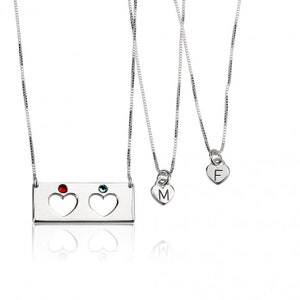May include: Three silver necklaces with heart pendants. The top necklace has a rectangular pendant with two cut-out hearts and red and blue gemstones. The middle necklace has a heart pendant with the letter "M" and the bottom necklace has a heart pendant with the letter "F".
