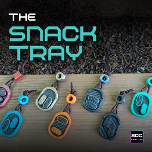 Puede incluir: La imagen muestra una colección de llaveros ovalados y coloridos. Cada llavero presenta una combinación de colores única, incluyendo rojo, azul, naranja y verde, con un diseño texturizado. El texto "THE SNACK TRAY" se muestra en la parte superior.