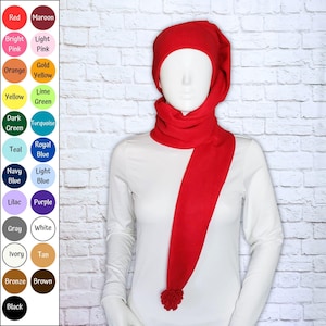 May include: A red fleece hat with an integrated scarf that wraps around the neck and features a pom-pom at the end. To the left, a color chart displays twenty circular swatches labeled with names including red, maroon, pink, orange, yellow, green, blue, purple, gray, white, ivory, tan, bronze, brown, and black.
