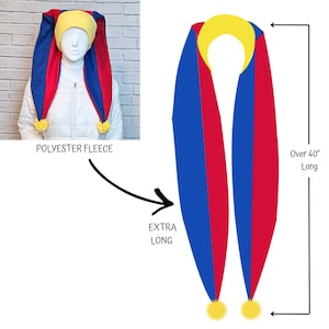 May include: A jester hat and scarf set made of polyester fleece. The hat is yellow with long blue and red panels, and yellow pom-poms. The scarf is over 40 inches long, with blue and red panels and yellow pom-poms. The text "EXTRA LONG" is visible.