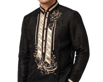 May include: A black long-sleeved barong tagalog shirt featuring a mandarin collar, a button-down placket, and intricate gold embroidery with swirling floral patterns and vertical striped panels on the front chest and sleeve cuffs.