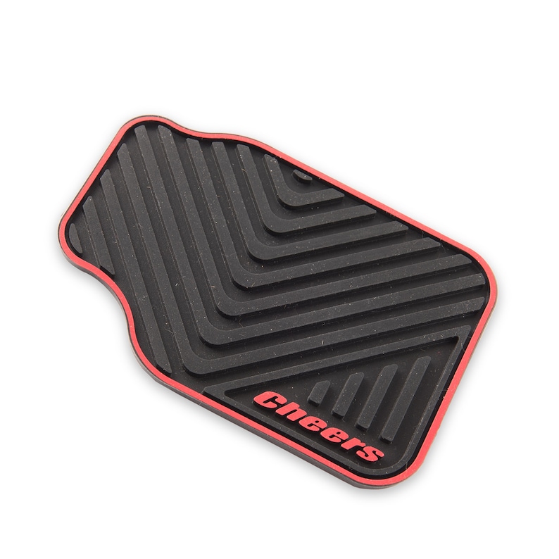 May include: Black rubber car floor mat with a red border and the word "Cheers" in red lettering.