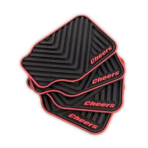 May include: Four black and red rubber drink coasters with the word "Cheers" printed in red on each coaster.