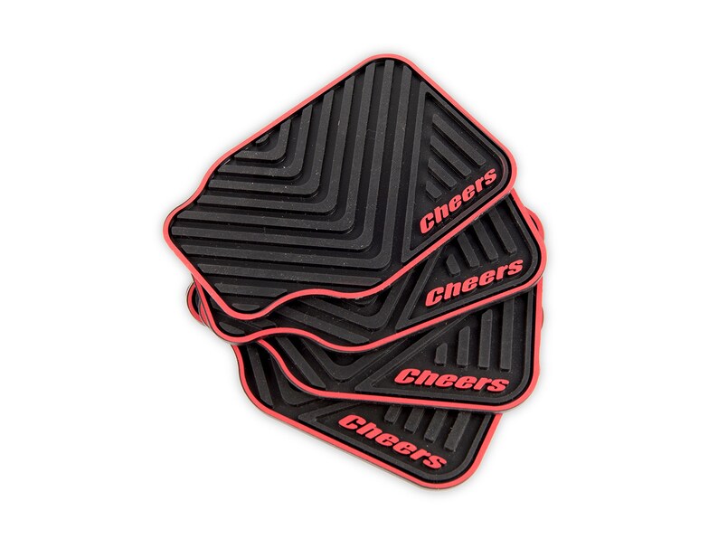 May include: Four black and red rubber drink coasters with the word "Cheers" printed in red on each coaster.