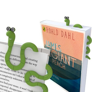 May include: Two green worm-shaped book marks. One is holding a book titled "James and the Giant Peach" by Roald Dahl.