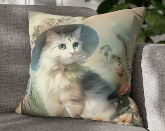 May include: A white and gray cat wearing a blue and white hat with floral accents. The cat is sitting on a floral background.