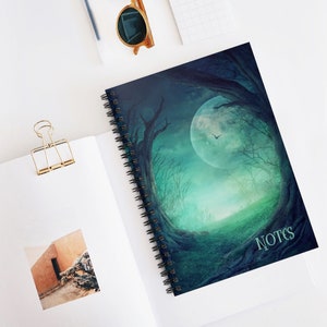 May include: A dark blue spiral notebook with a full moon and trees in the background. The text "NOTES" is printed in white on the cover.