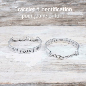 May include: Two silver bracelets with engraved text. One bracelet has the name "Emile" engraved with stick figure drawings of children. The other bracelet has the text "GOTTIER 514*555*1238" engraved.