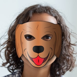 May include: A child wearing a brown paper dog mask with a red tongue. The mask has black eyes and a black nose.