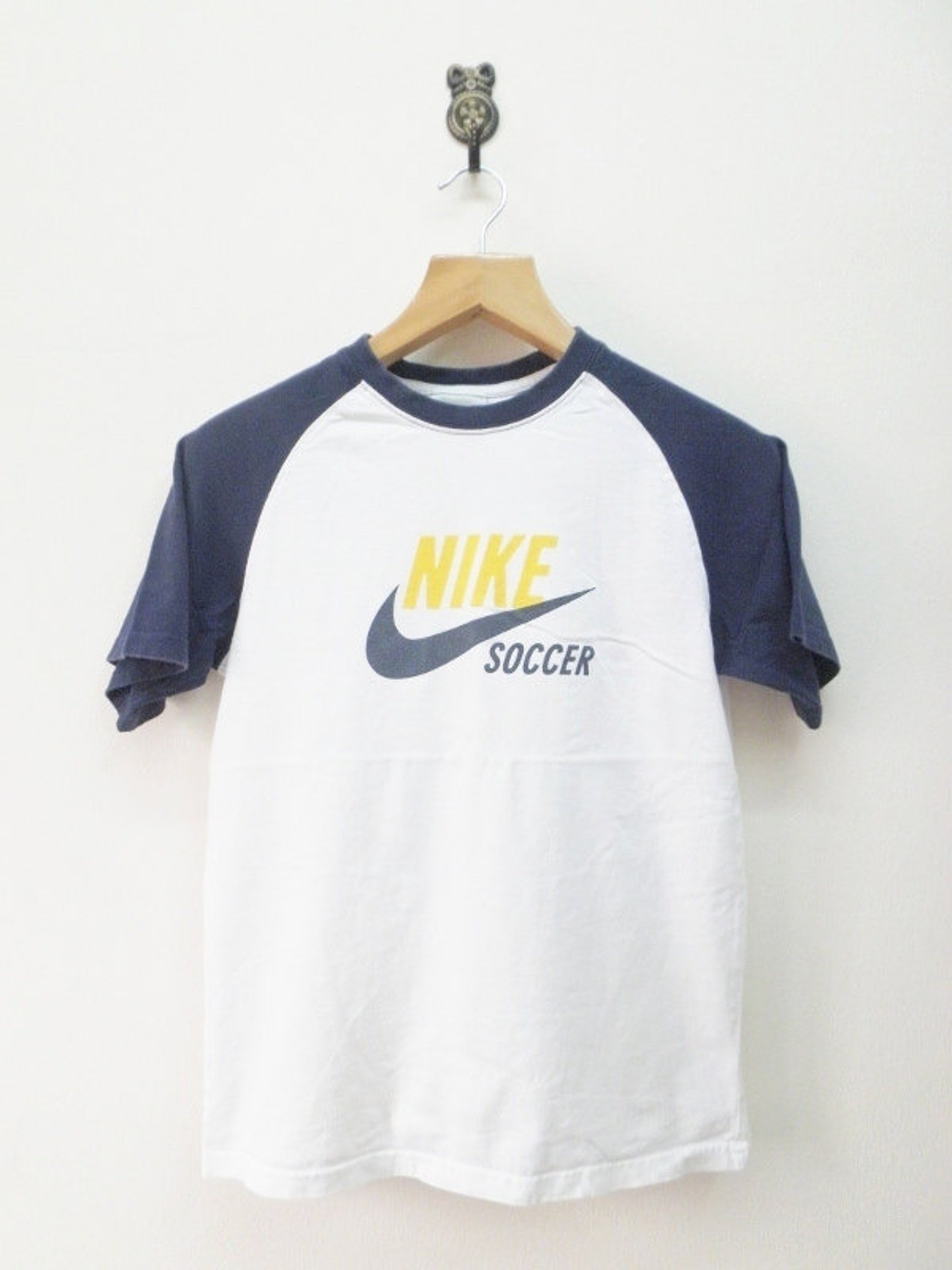 white nike shoe with red swoosh