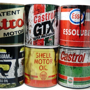 May include: Six vintage-style metal mugs with different motor oil brands, including Castrol, Esso, and Shell. The mugs are all rusty and have a distressed look.