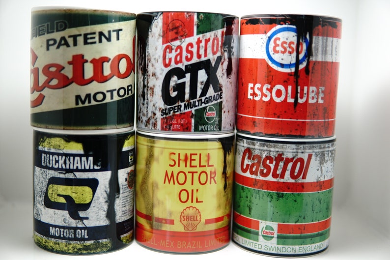May include: Six vintage-style metal mugs with different motor oil brands, including Castrol, Esso, and Shell. The mugs are all rusty and have a distressed look.