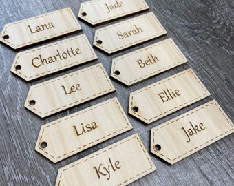 May include: Ten wooden name tags with names written on them. The names are: Lana, Jade, Sarah, Charlotte, Beth, Lee, Ellie, Lisa, Jake, and Kyle.