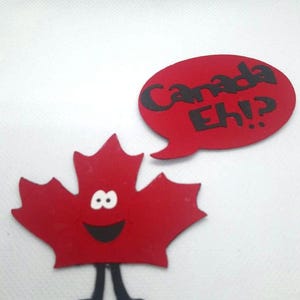 May include: A red maple leaf with a smiling face and legs, holding a speech bubble that says "Canada Eh!?"