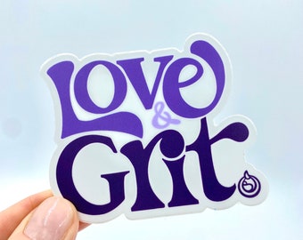 May include: Purple and white sticker with the text "Love & Grit" in a stylised font. A small circle with a stylised heart inside is in the bottom right corner.