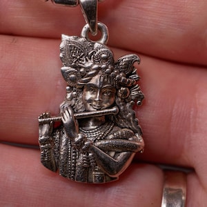 Krishna with Flute silver pendant with a silver chain would be a spiritually significant piece of jewelry for devotees of Lord Vishnu