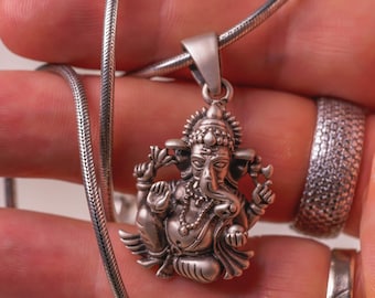 Discover this beautifully crafted pure silver pendant depicting Lord Ganesha, the auspicious deity, complete with a matching silver chain.