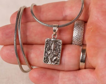 Discover this beautifully crafted pure silver pendant depicting Lord Ganesha, the auspicious deity, complete with a matching silver chain.