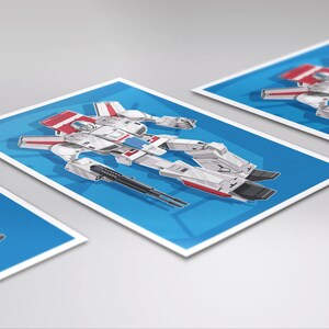 May include: A white, red, and blue robot toy in a cartoon style. The robot is in a standing position with its arms outstretched. The robot has a large head with a visor and a small mouth. The robot is holding two guns in its hands.