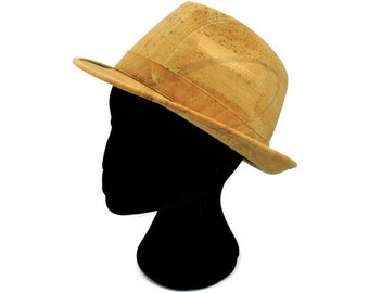 May include: A tan cork fedora hat with a wide brim. The hat is on a black mannequin head.