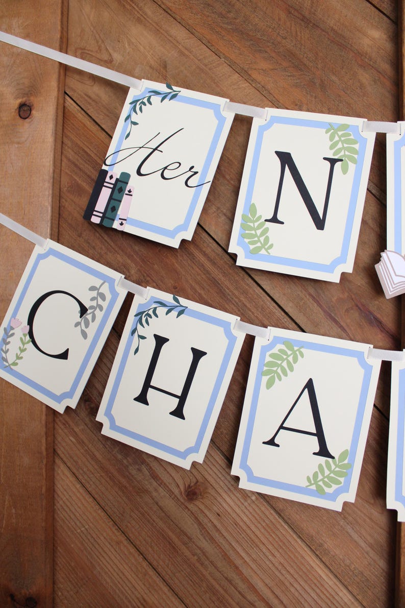 May include: A banner spelling "Her N Cha" with individual rectangular flags. Each flag has a white background with a light blue border and decorative floral elements. The letters are black. The first flag has the word "Her" in script.