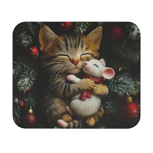 May include: A brown tabby cat with green eyes is sleeping with its arms wrapped around a white mouse with red and white scarf. The cat and mouse are surrounded by green pine branches and red Christmas ornaments.