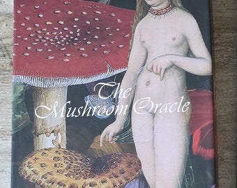 May include: A card deck and guidebook titled "The Mushroom Oracle". The cover depicts a nude figure amidst large red and brown mushrooms. The text on the cover reads "The Mushroom Oracle" and "44 Card Deck and Guidebook".