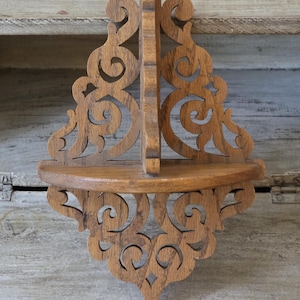 Small vintage red oak wood wall shelf with scroll-saw cutout patterns