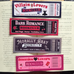 May include: Four colorful bookmarks with a book club theme. Each bookmark features a different design with a dark background and colorful accents. The bookmarks include the text "Villain Lovers Bookclub", "Dark Romance Bookclub", "Morally Gray Bookclub", and "Enemies to Lovers Bookclub".