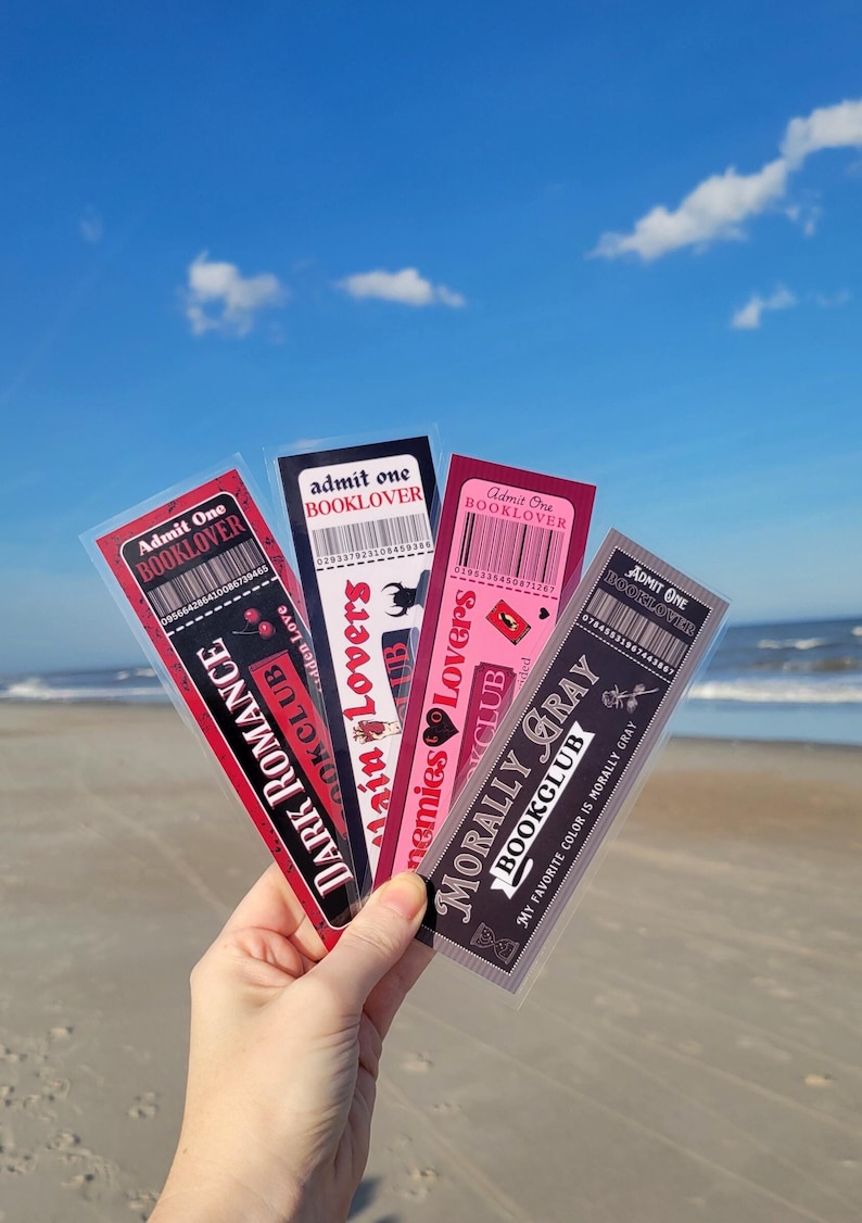 May include: Four colorful bookmarks with black and white text. The bookmarks are labeled "Dark Romance Book Club", "Enemies to Lovers Book Club", "Morally Gray Book Club", and "Admit One Booklover".