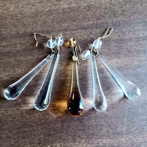 May include: A white ceramic mug with a black handle and the text "But First, Coffee" in a bold, black font. The mug is set against a plain white background.